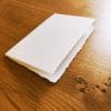 Wedding invitations in Amalfi paper. Ivory color with straw. Foldable design