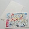 Cartolina pieghevole in carta di Amalfi con illustrazione di un fondale marino ricco di pesci.