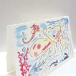 Folding greeting card in Amalfi paper. The illustration represents a seabed rich in fish and biodiversity.