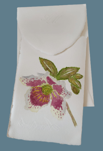 Amalfi paper invitations with watercolor flower decorations. On the cover of this model there is an hellebore flower.