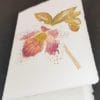 Bigliettini di auguri pieghevoli in carta di Amalfi con decoro di un elleboro ad acquerello.