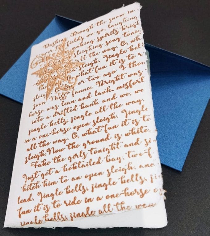 Folding Christmas cards made of Amalfi paper. The decoration is handmade with gold embossing and represents part of the lyrics of the Christmas song "Jingle bells".