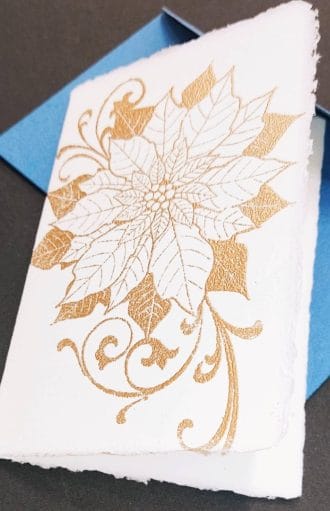 Amalfi paper cards with a handmade poinsettia decoration with gold embossing.