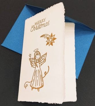 Biglietti pieghevoli in carta di Amalfi con decoro di una cometa di Natale realizzata a mano con dorature a rilievo.