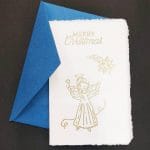 Amalfi paper cards with gold embossing. On the main facade the representation of a Christmas angel below a comet.