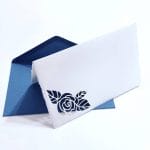 Folding card in Amalfi paper with perforated rose. Envelope color: blue