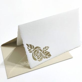 Folding cards in Amalfi paper with perforated rose petal. Envelope color: Hazelnut