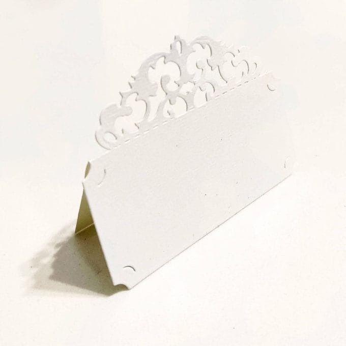 Place marker in Amalfi paper with baroque style fretwork. Ivory color
