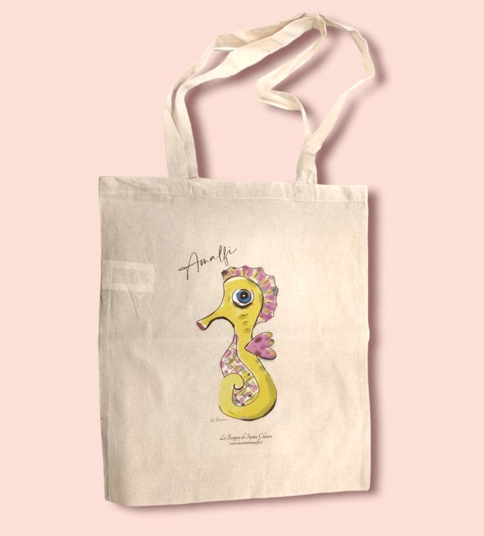 La tote bag de Lo Scrigno di Santa Chiara con decoro stilizzato del cavalluccio marino.